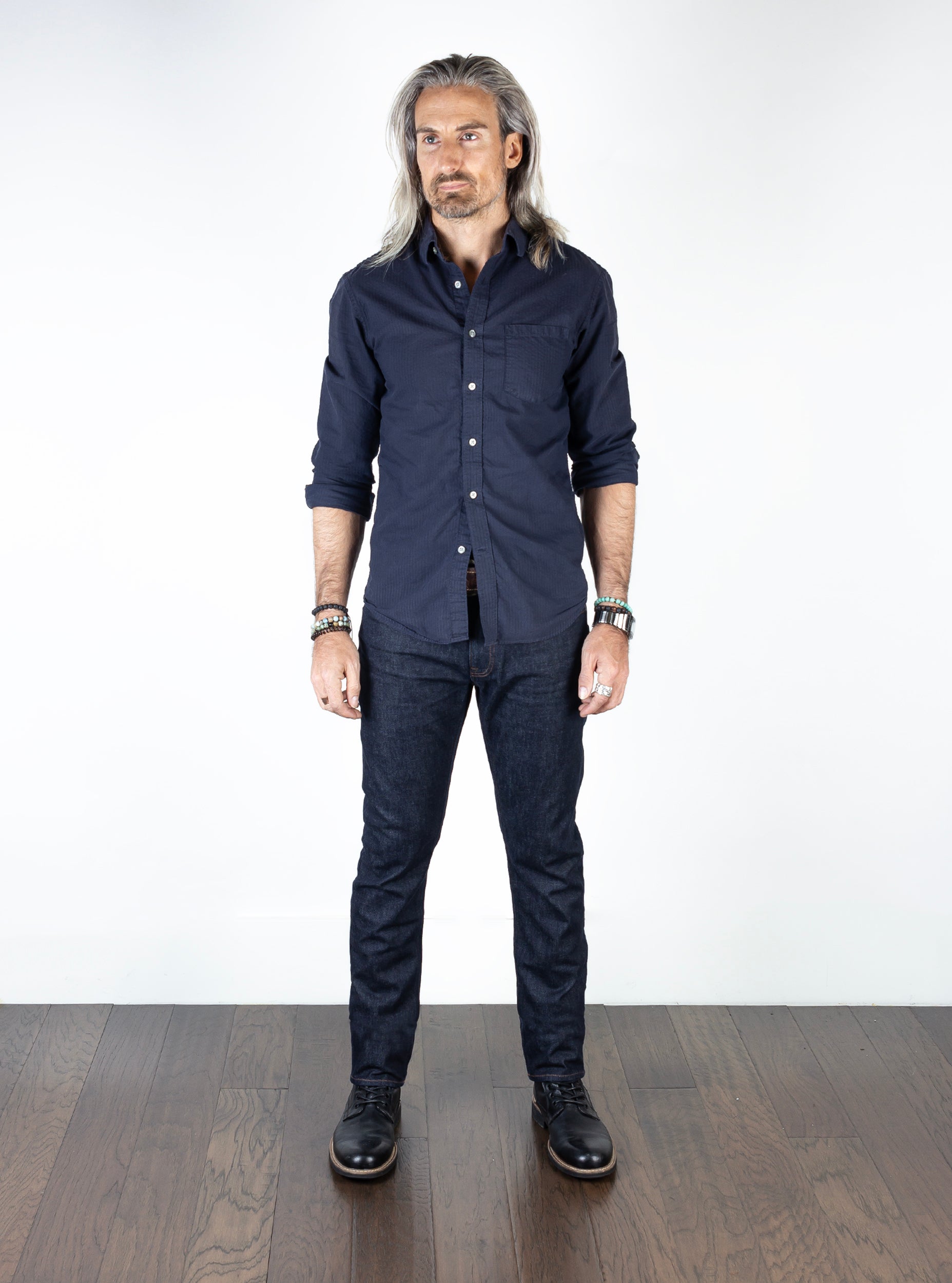 Model wearing the Axe Raw Slim Straight Comfort Fit Jeans, front-facing, emphasizing the artisan craftsmanship and premium Italian denim.