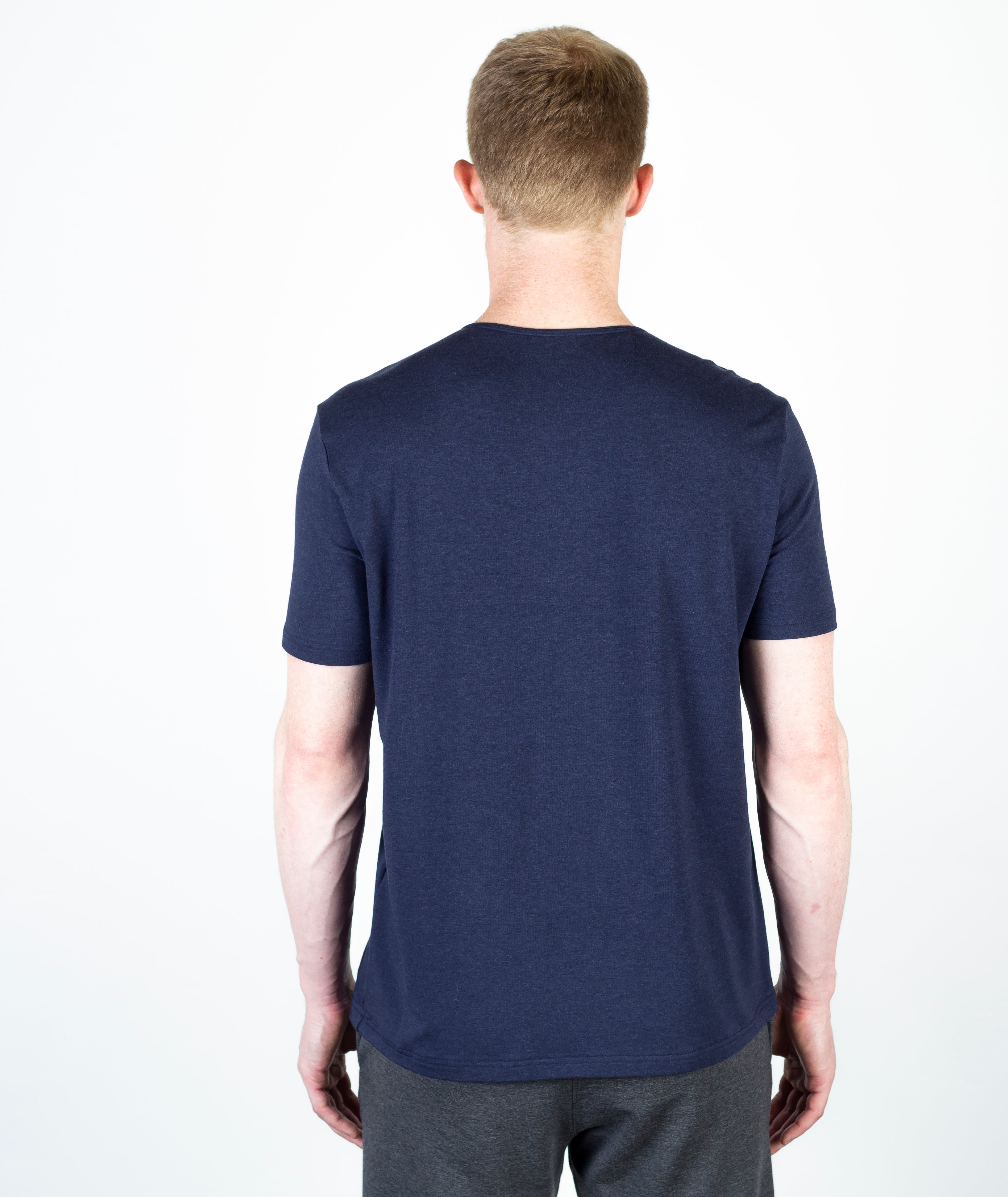 Model wearing the Bolt Slim Fit Luxury Short Sleeve T-Shirt in Navy, facing away, highlighting its sustainable fabric, sleek design, and perfect fit.