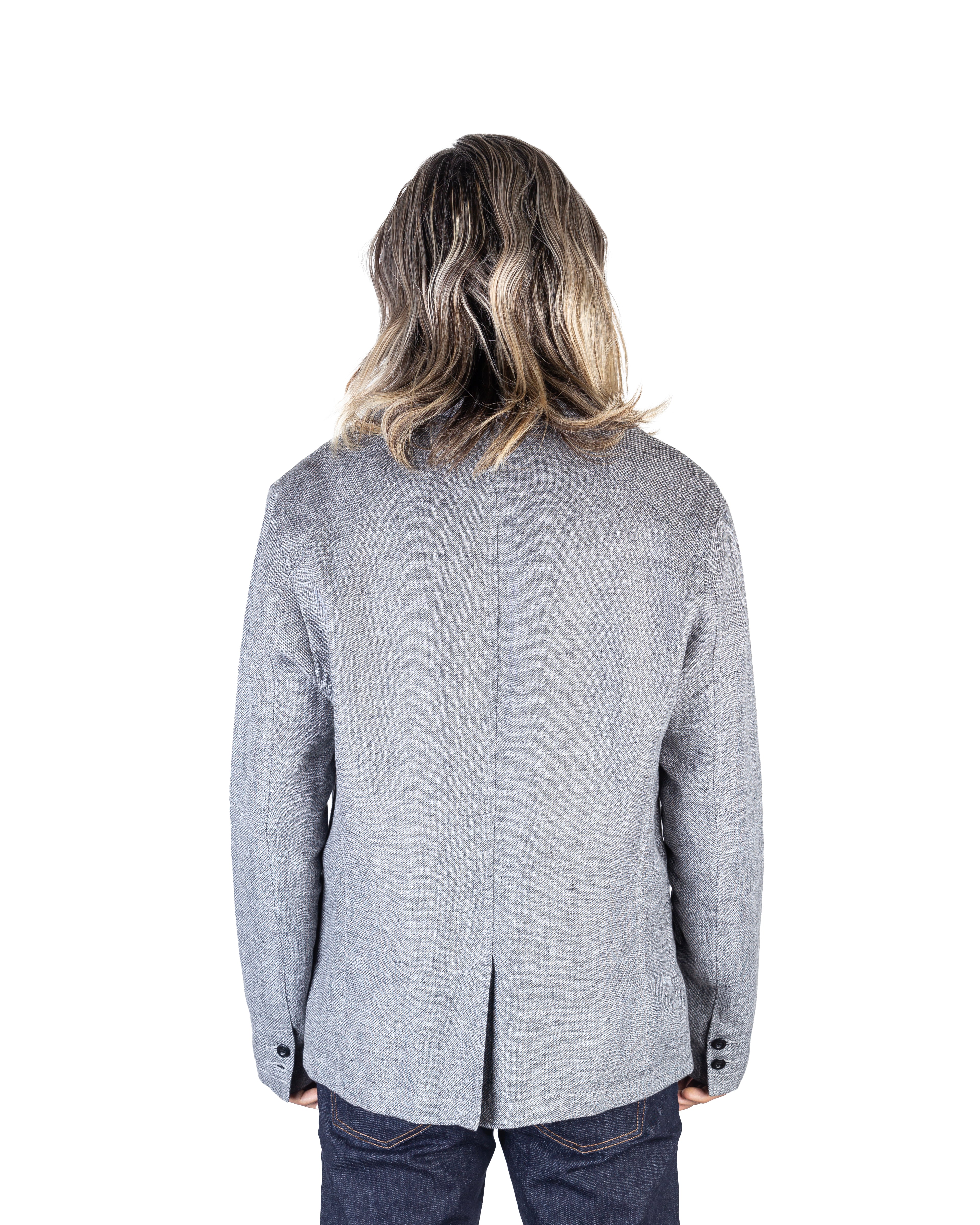 Model wearing the Engineered Slim Linen Jacket in Fermi Grey, facing away, highlighting the jacket's sleek design and premium finish.