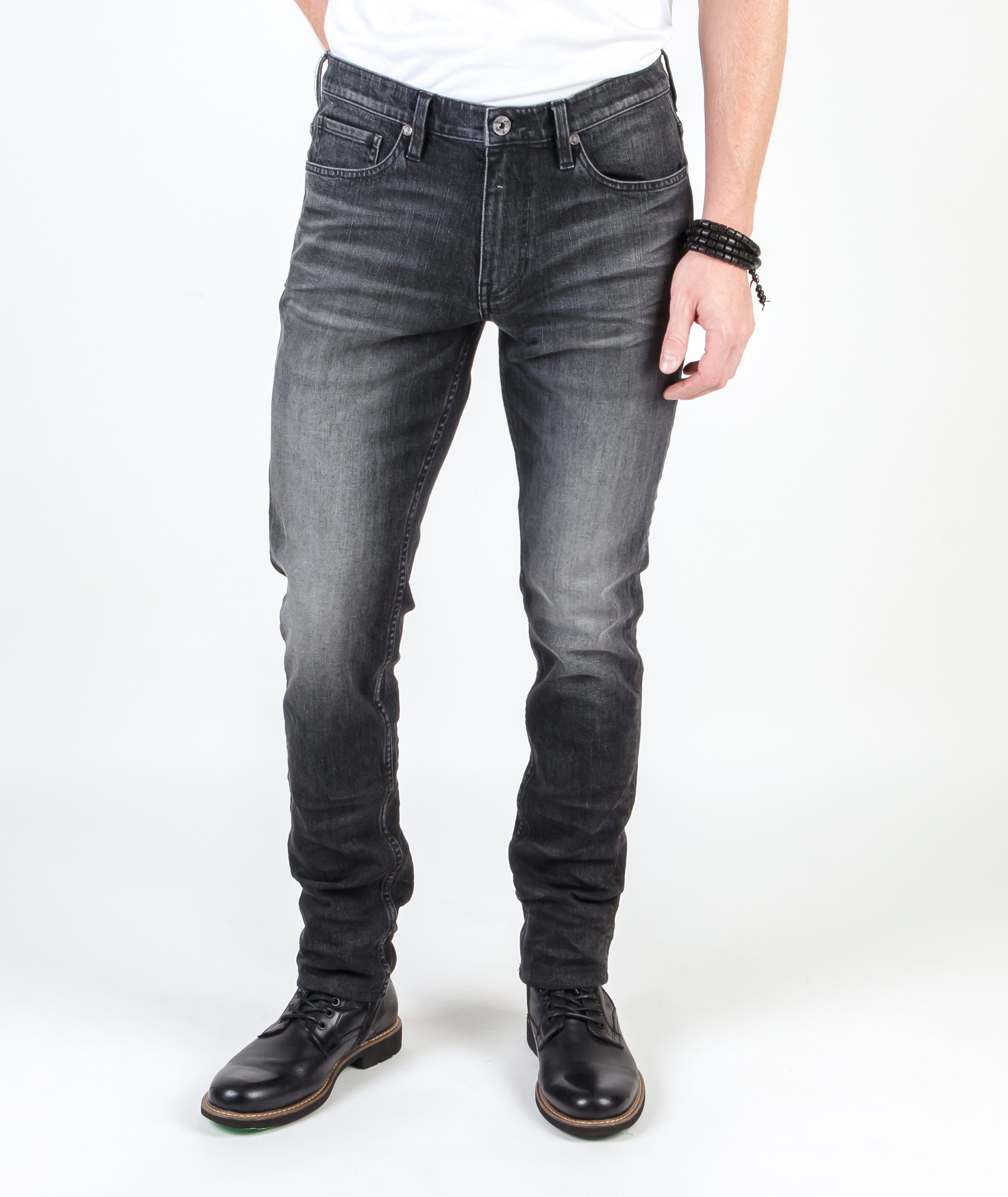 Blade Smoke Slim Tapered Fit Jeans worn by model, emphasizing the sleek, vintage black design and sustainable craftsmanship.