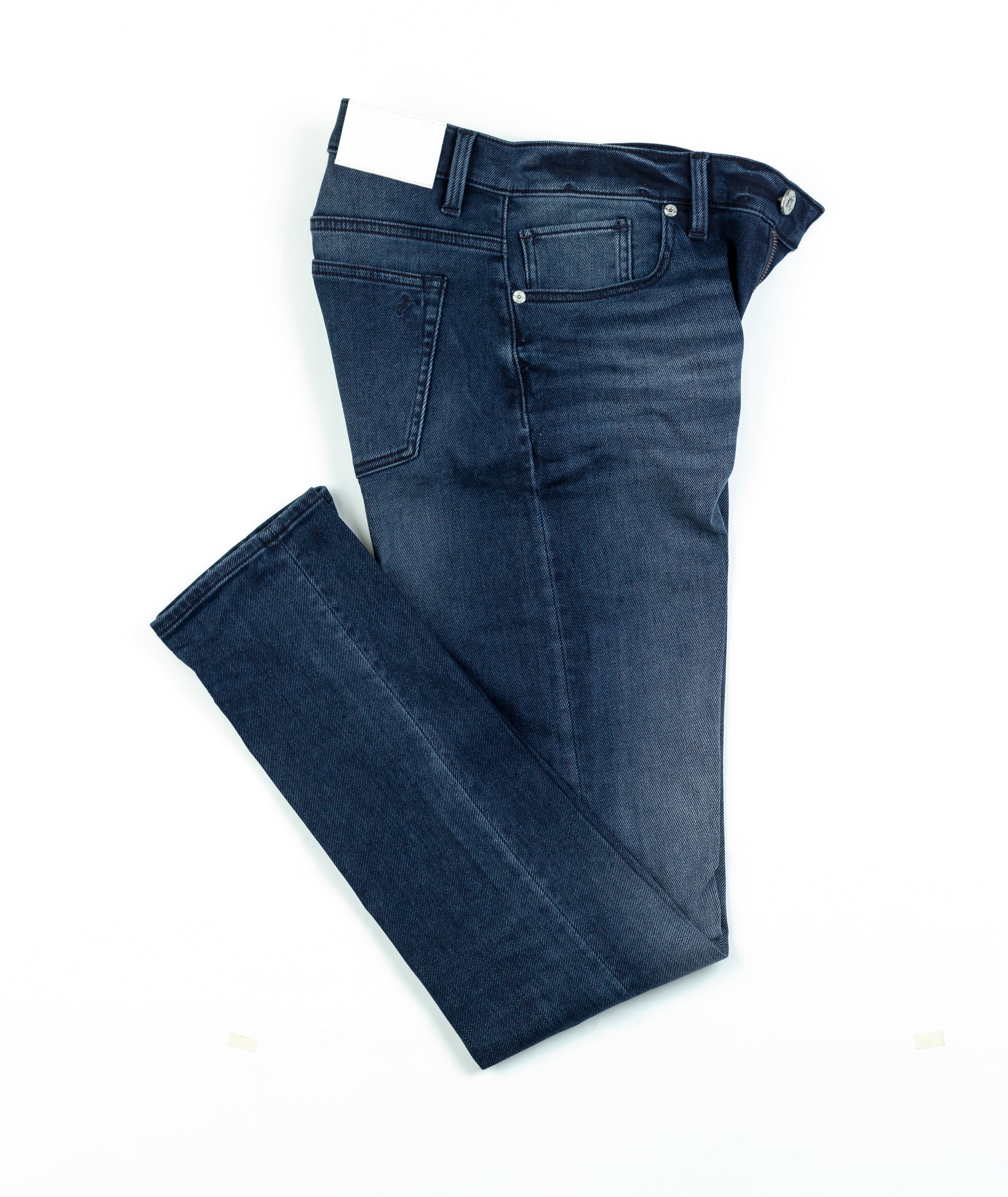 Axe Noche Slim Straight Comfort Fit Jeans in a folded flat lay, showcasing the luxurious denim weave and modern design details.