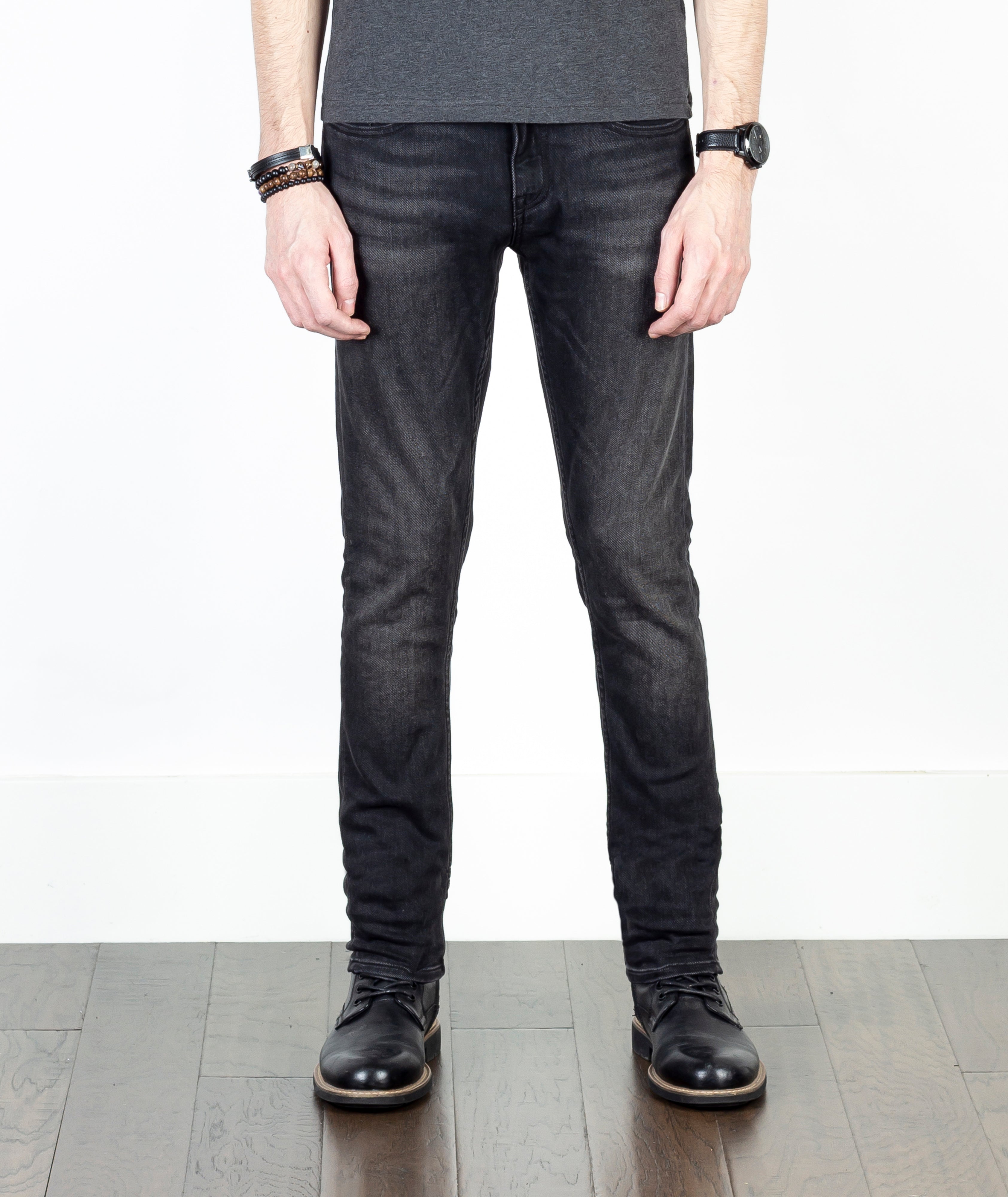 Close-up of a model wearing Axe Smoke Slim Straight Comfort Fit Jeans, front view, highlighting the smooth fit and luxurious fabric made from sustainable materials.